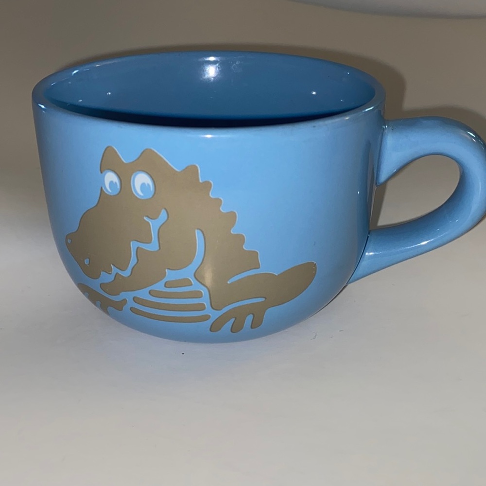 Light blue crocs, promotional mug, alligator on front rear find